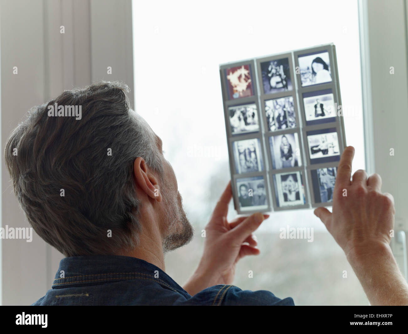 Mature man looking at old slides Stock Photo - Alamy