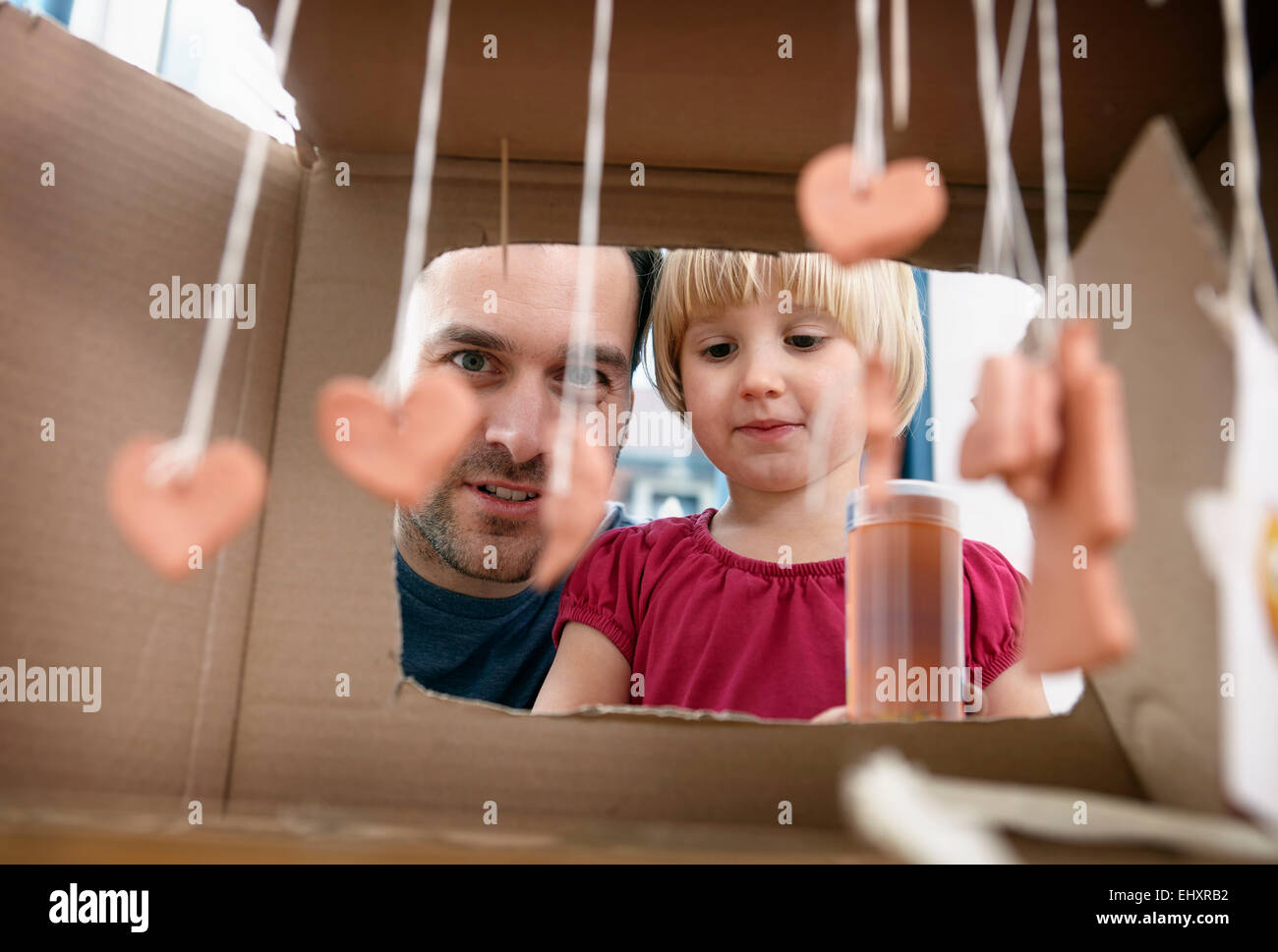 Father and kids playing with self made toys Stock Photo