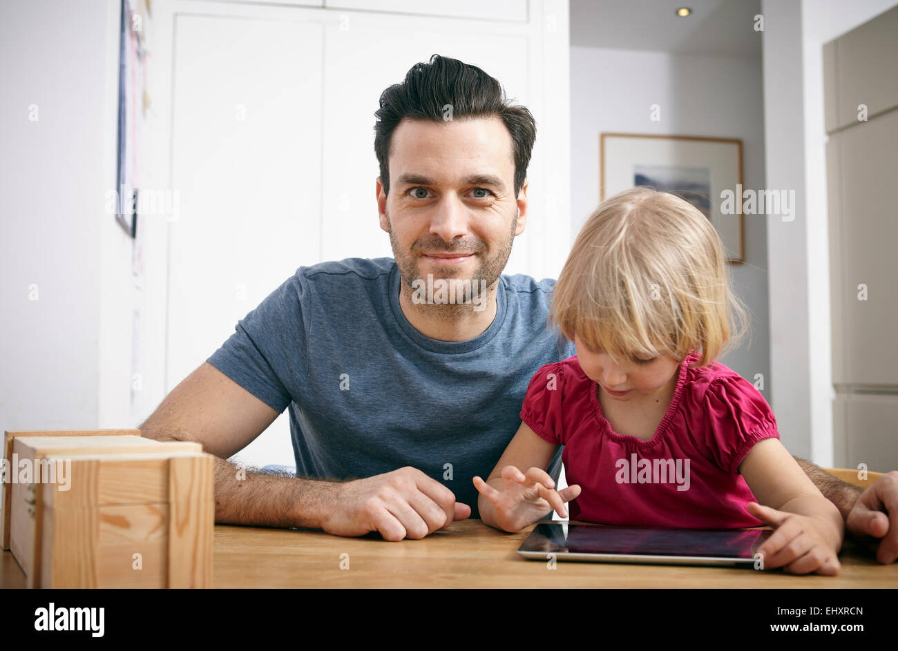 Father and little daughter using digital tablet Stock Photo