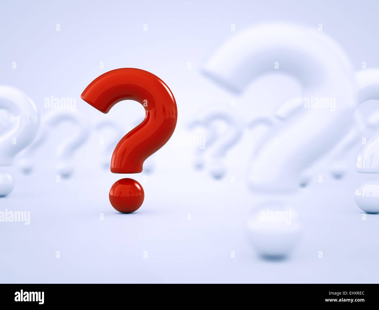 Red question mark standing out amid white question marks Stock Photo