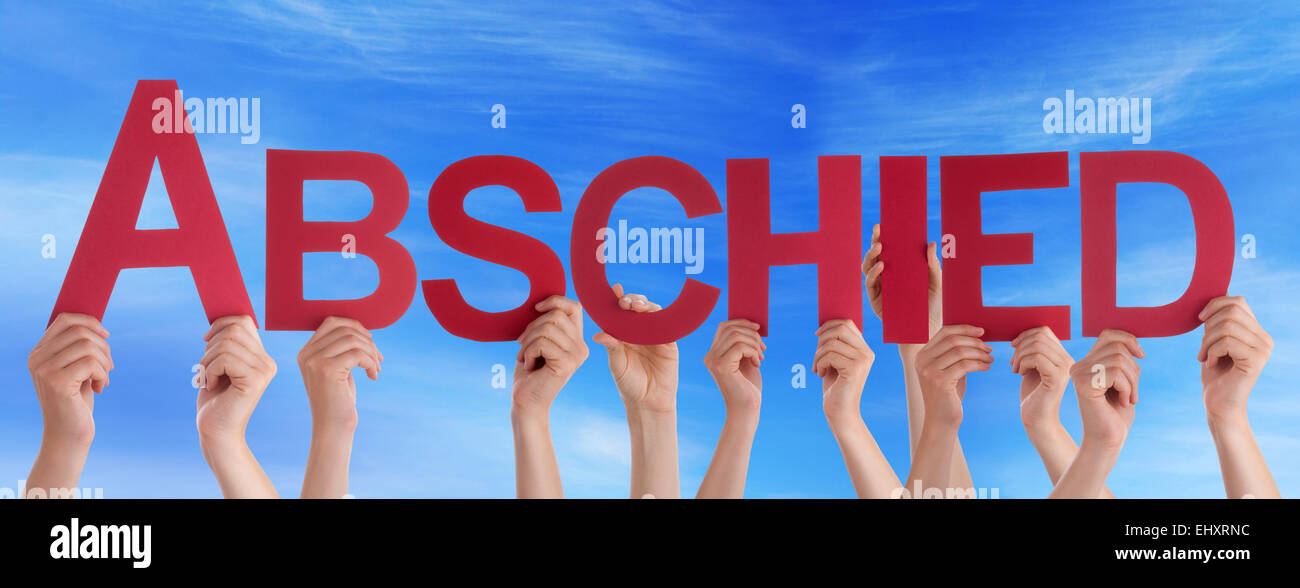 Many Caucasian People And Hands Holding Red Straight Letters Or Characters Building The German Word Abschied Which Means Goodbye Stock Photo