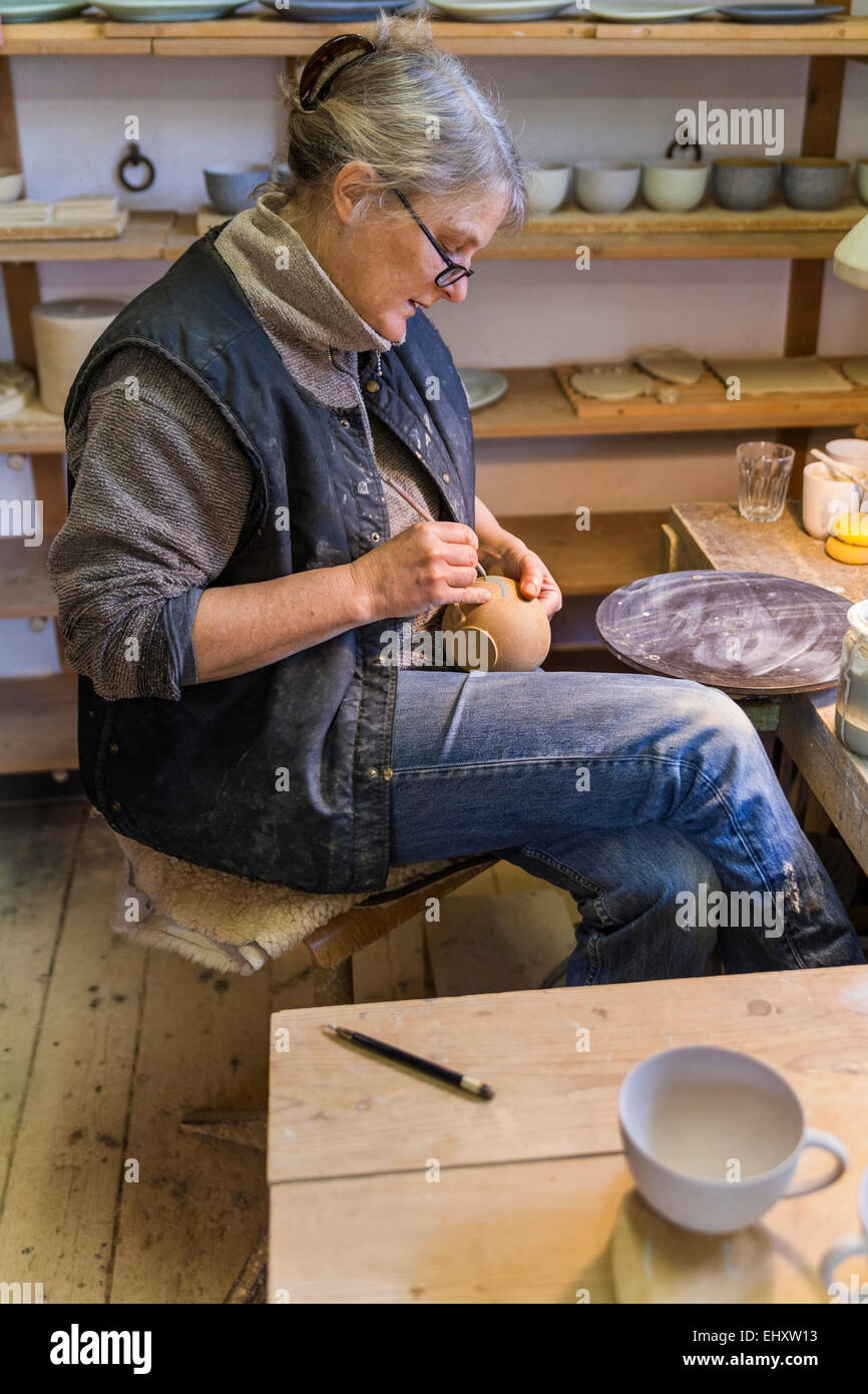 Potter in workshop painting a bowl Stock Photo - Alamy