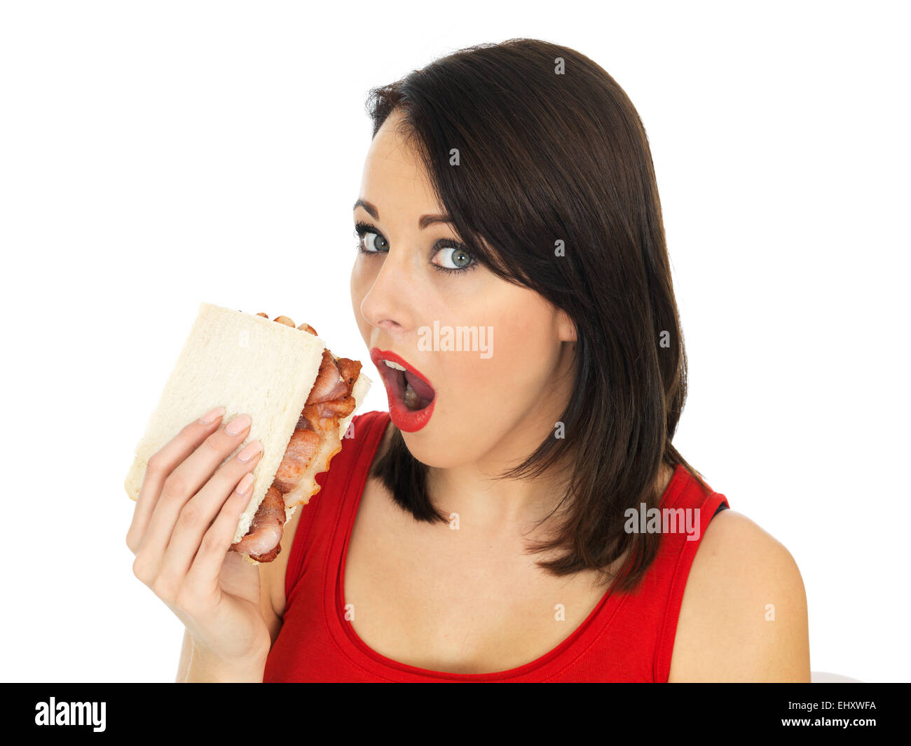 Attractive Young Woman Eating a Bacon Sandwich Stock Photo