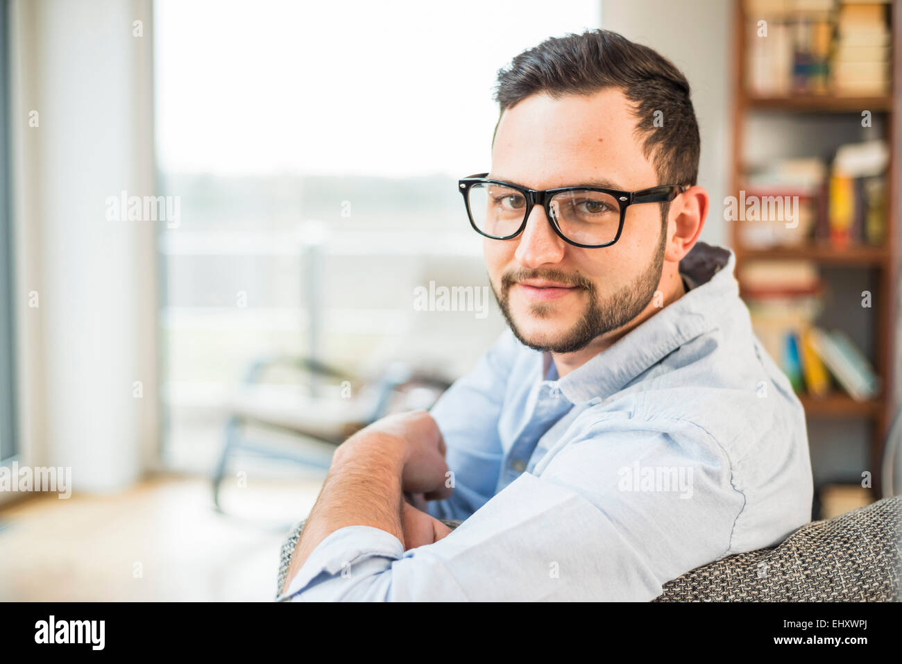 Portrait of smiling young man with glasses Stock Photo - Alamy