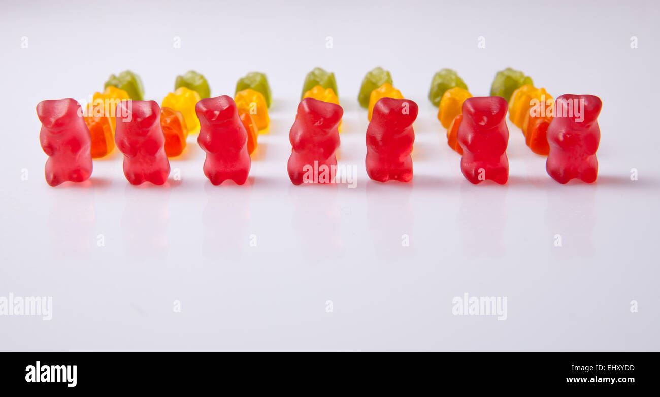 Rows of colorful gummy bears isolated over white background Stock Photo
