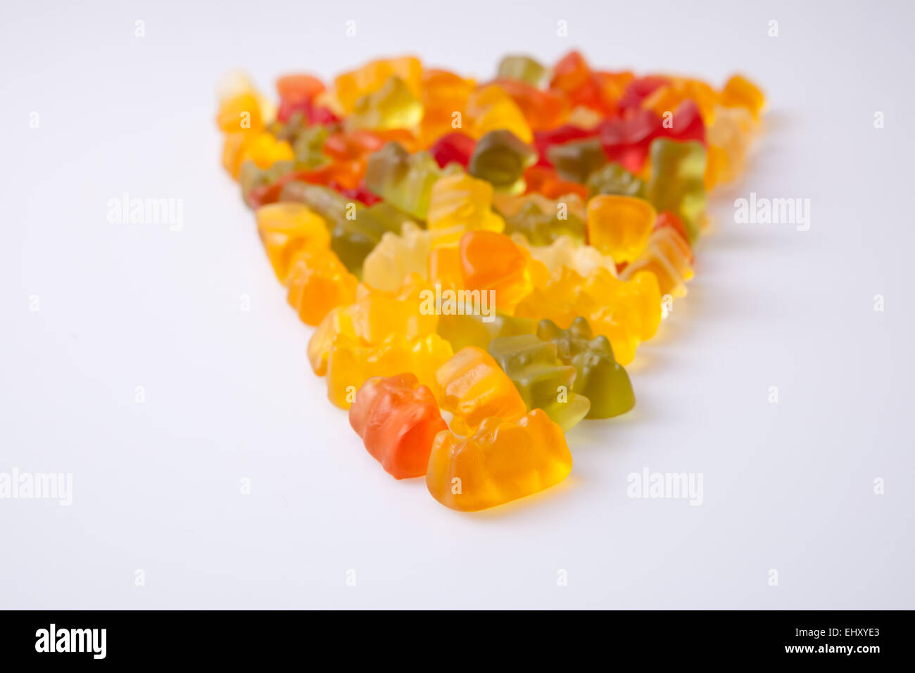 Arrow of colorful gummy bears isolated over white background Stock Photo