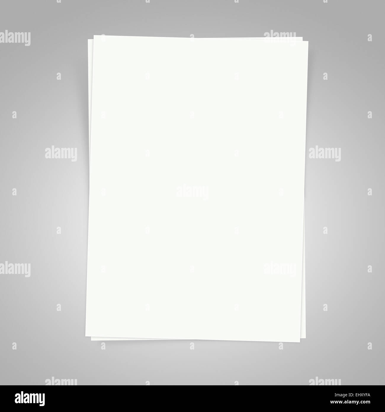 Blank white papers on a gray background with shadows Stock Photo