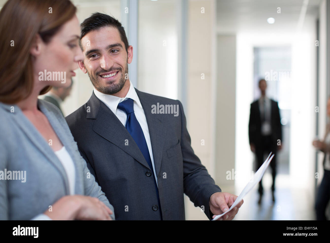 Businessman and businesswoman meeting on office floor Stock Photo - Alamy