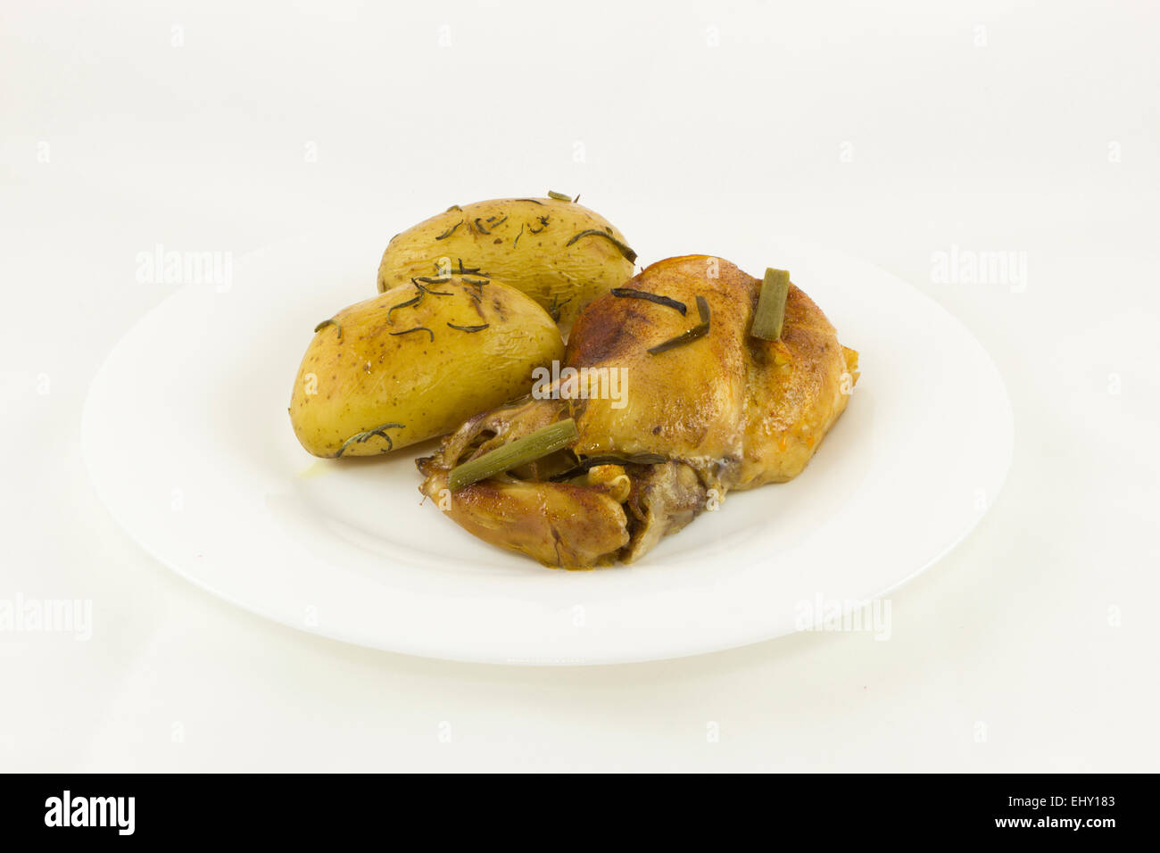 A delicious Rabbit stew and baked potatoes with rosemary Stock Photo