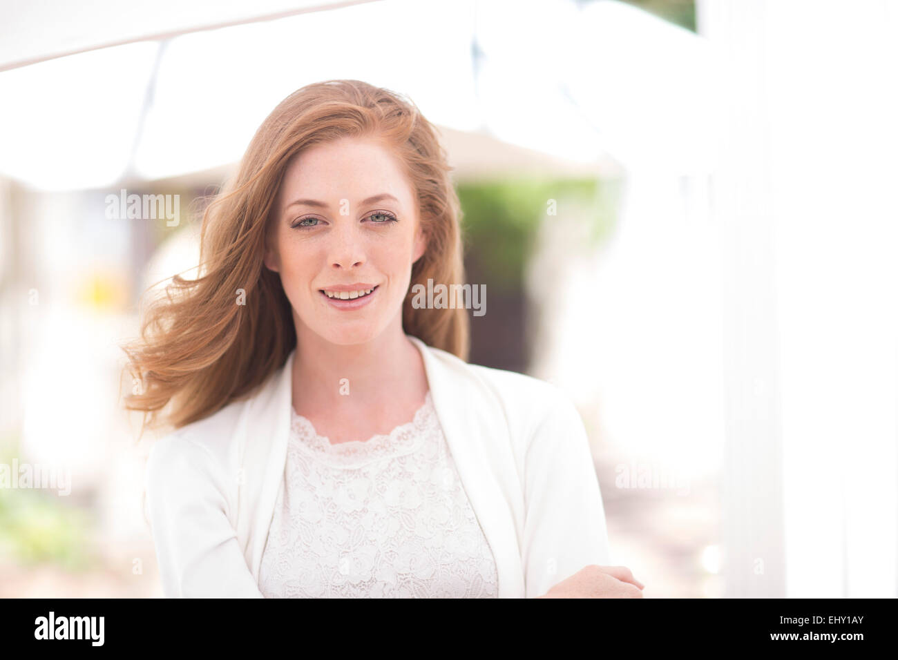 Portrait of smiling young woman outdoors Stock Photo - Alamy
