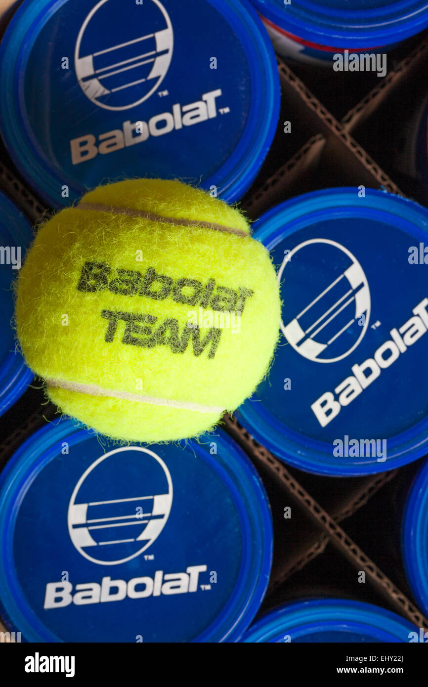 Tubs of Babolat Team tennis balls in box with tennis ball resting on top Stock Photo