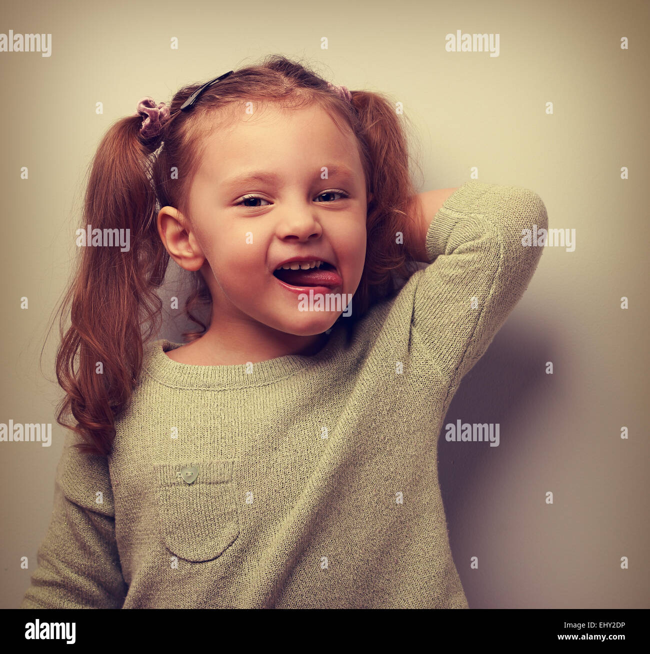 Happy fun kid girl posing in blouse and showing tongue. Vintage ...