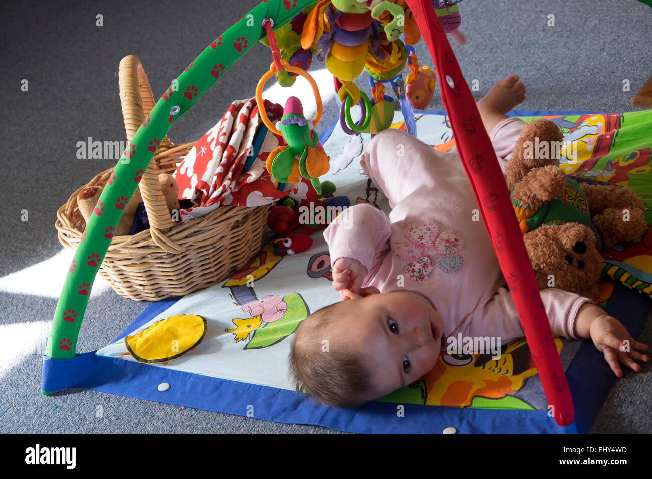 8 month old baby girl playing with interactive toy Stock Photo