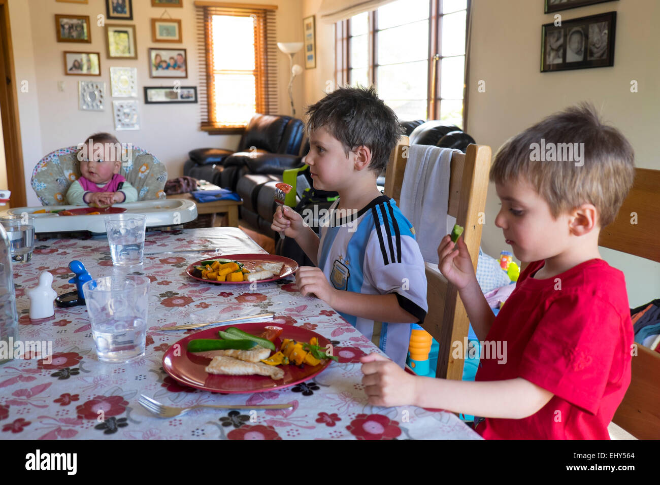 Children eating a healthy meal at home Stock Photo