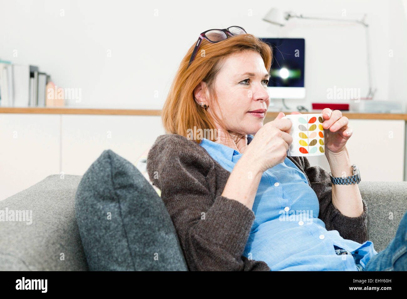Senior woman having a cup of coffee at home Stock Photo