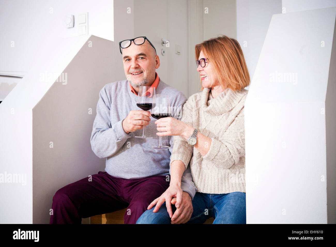 Senior couple drinking a glass of red wine Stock Photo