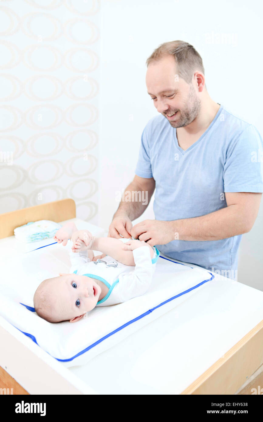 Father changing baby's nappy Stock Photo
