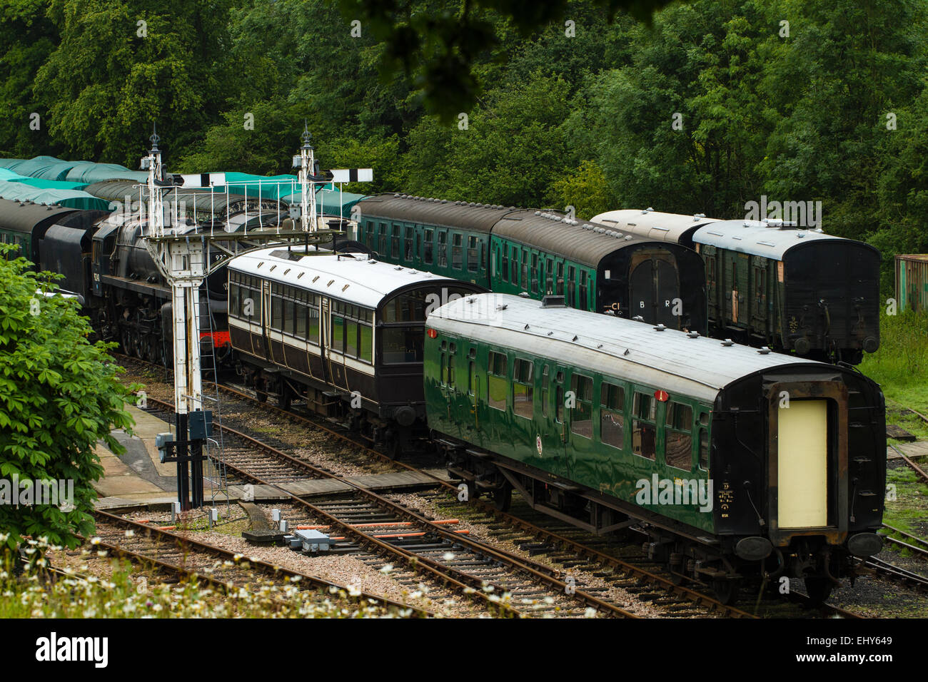 Coaches and a steam engine with semaphore signals on the Bluebell Railway, a heritage line in West Sussex Stock Photo