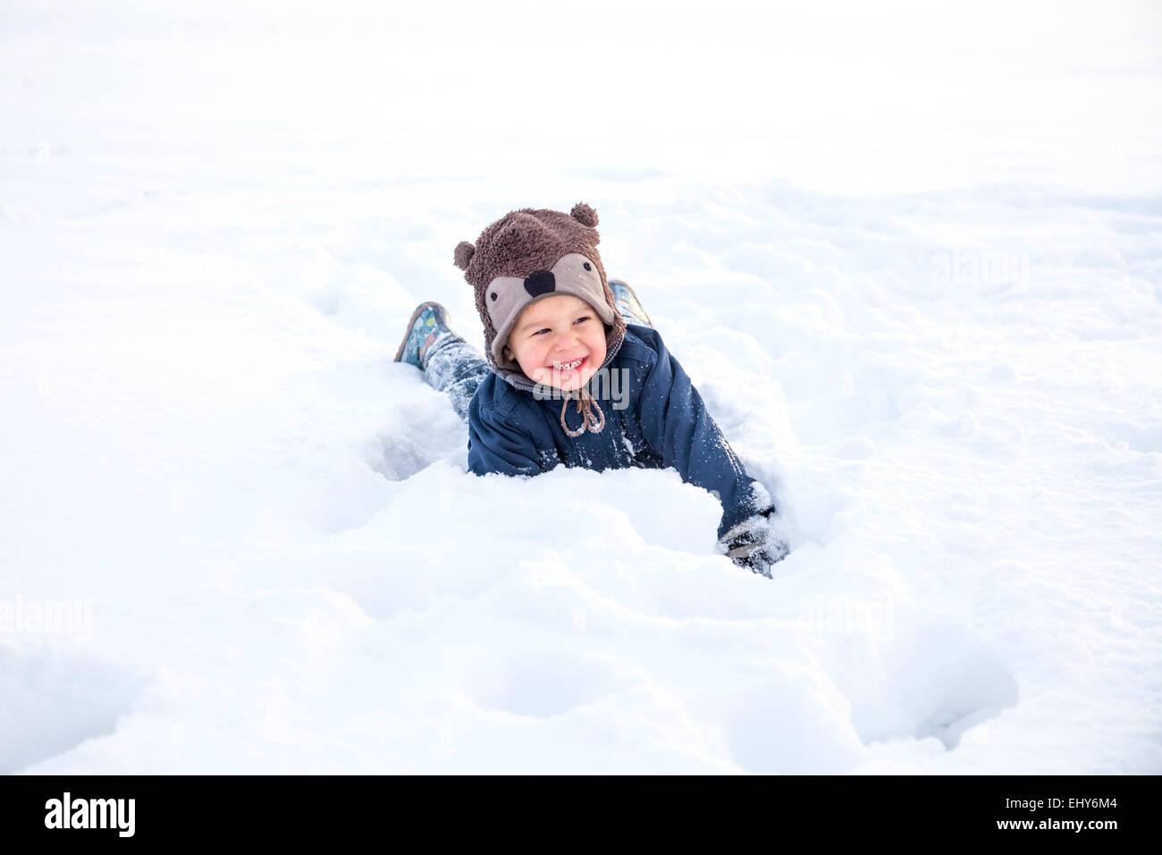 Little boy with bear costume playing in snow Stock Photo - Alamy