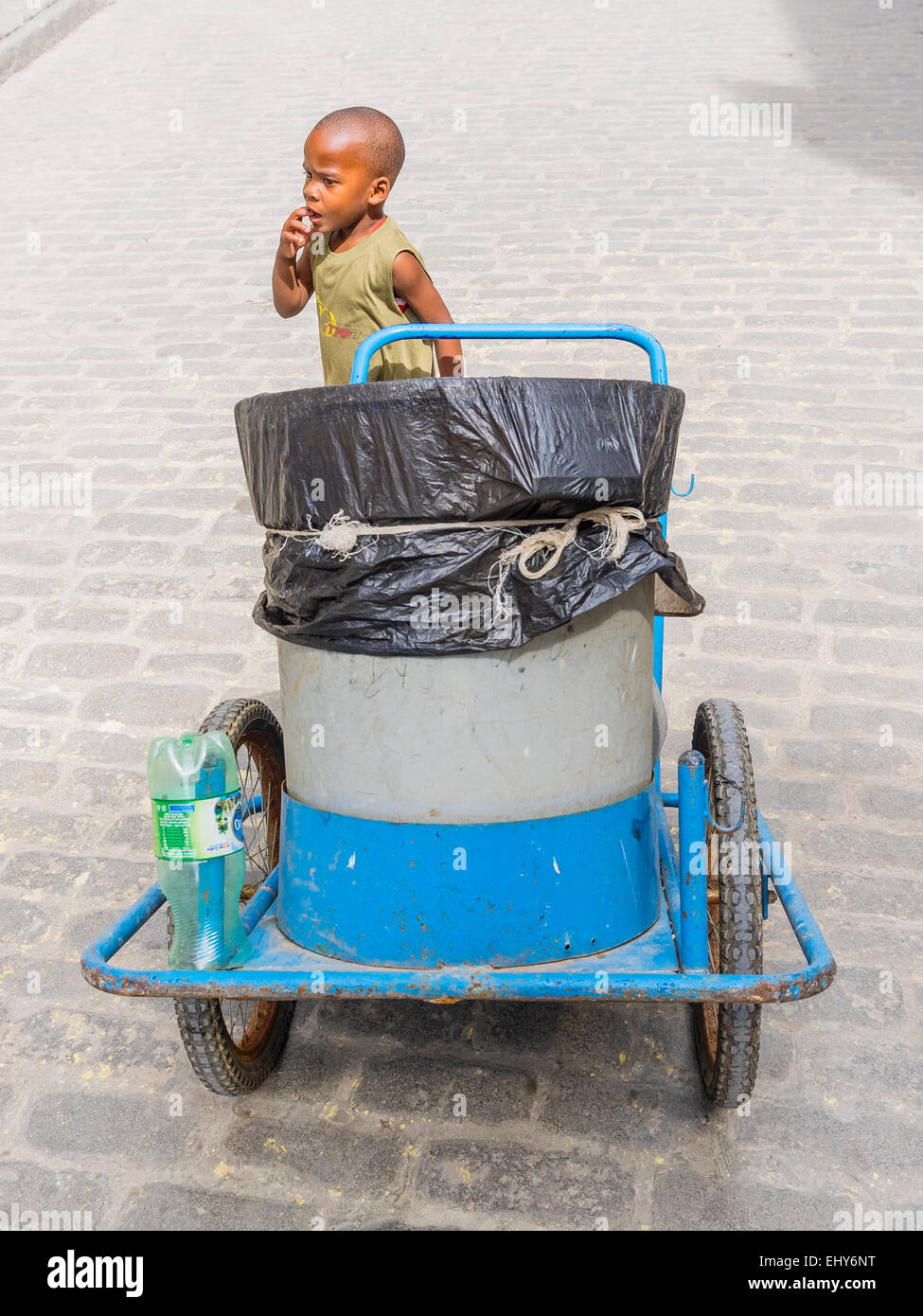 A young Cuban boy pushes a trash cart through the streets of Havana, Cuba Stock Photo Alamy