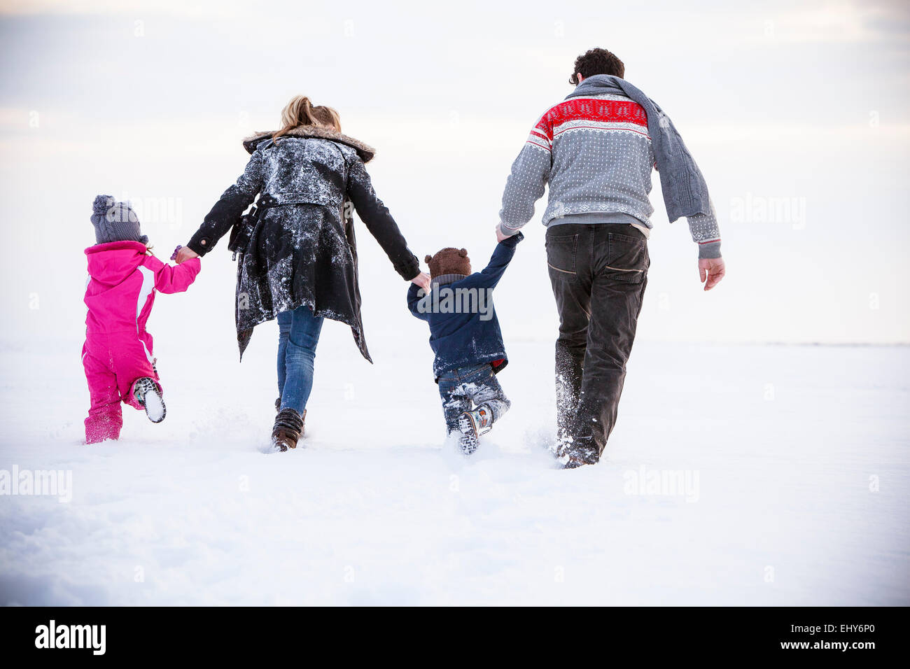 Woman 3 children walking snow rear view hi-res stock photography and ...