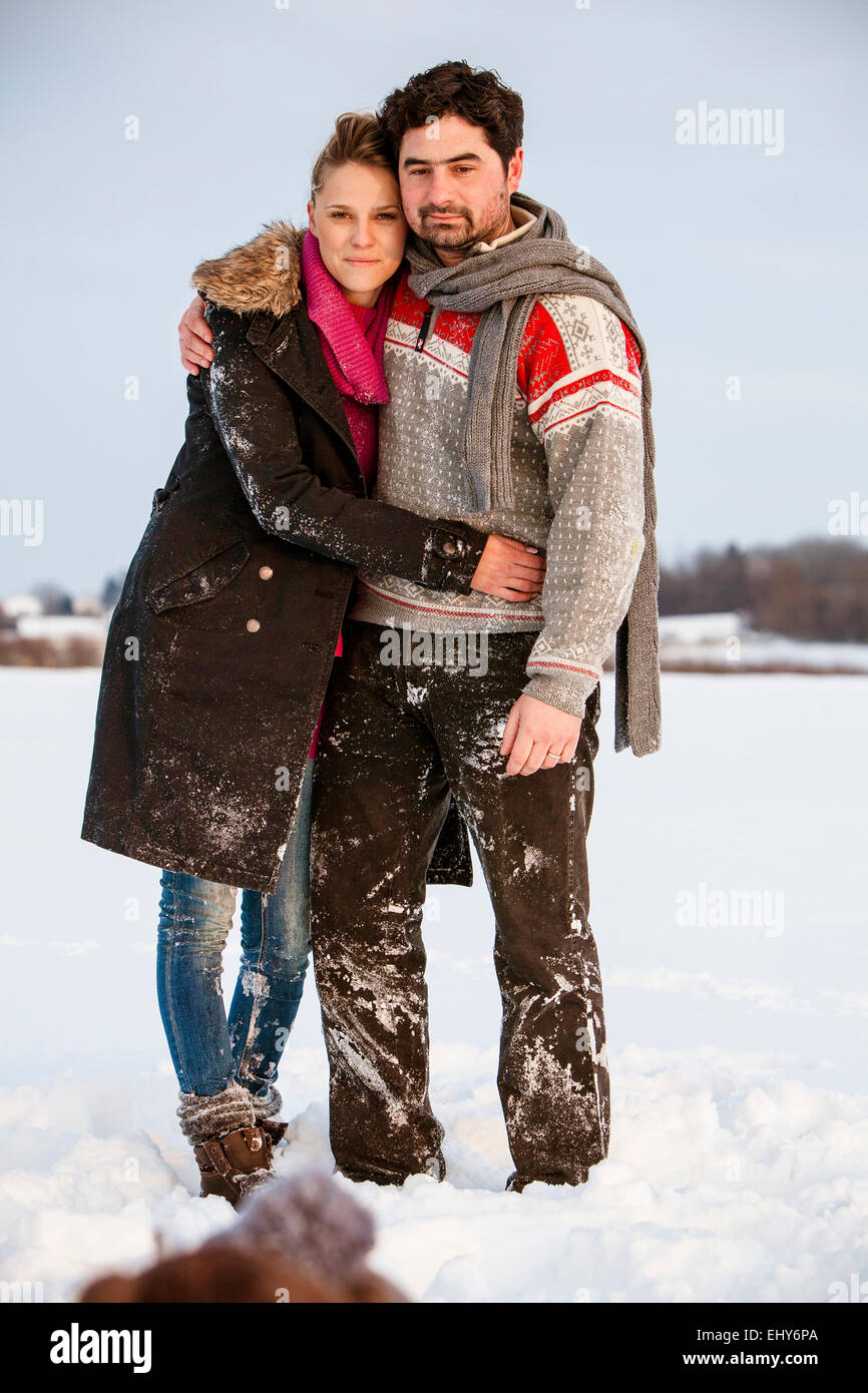 Couple embracing in snowy landscape Stock Photo - Alamy