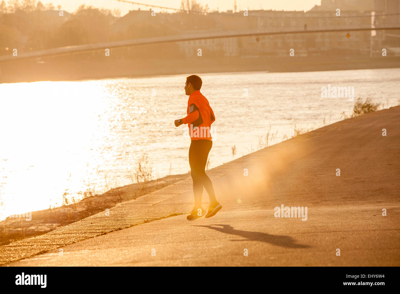 Male runner warming up at sunset Stock Photo