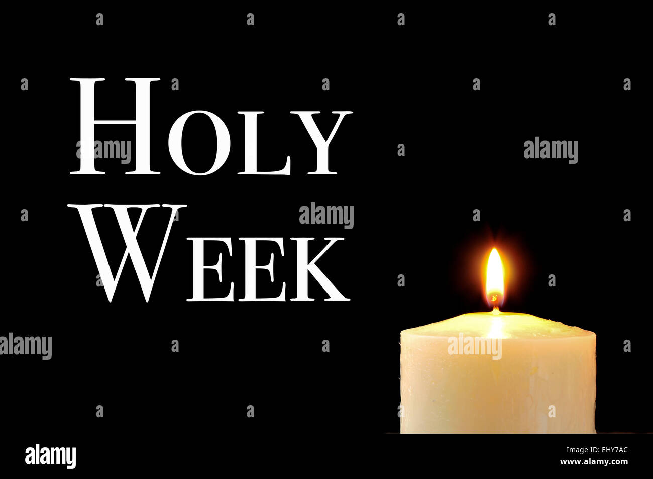 a lit candle and the text holy week written in white on a black background Stock Photo