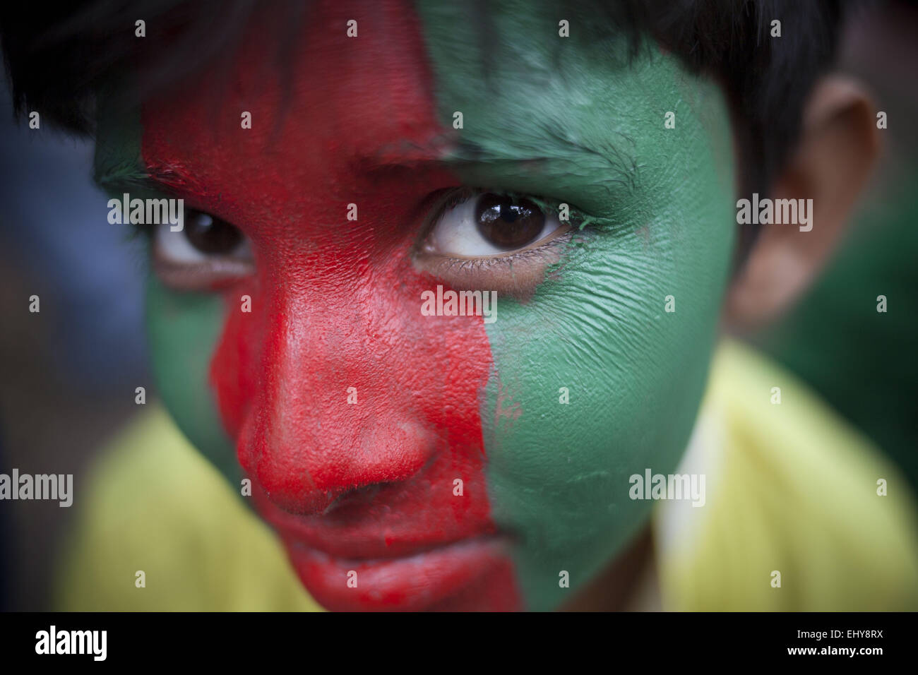 Dhaka, Bangladesh. 18th Mar, 2015. A member of Bangladesh Cricket Fans Unity paints his face in the colors of the Bangladesh national flag as they hold a 'Flag-rally' to inspire the Bangladesh cricket team ahead of the ICC World Cup quarterfinal match against India. © Suvra Kanti Das/ZUMA Wire/ZUMAPRESS.com/Alamy Live News Stock Photo