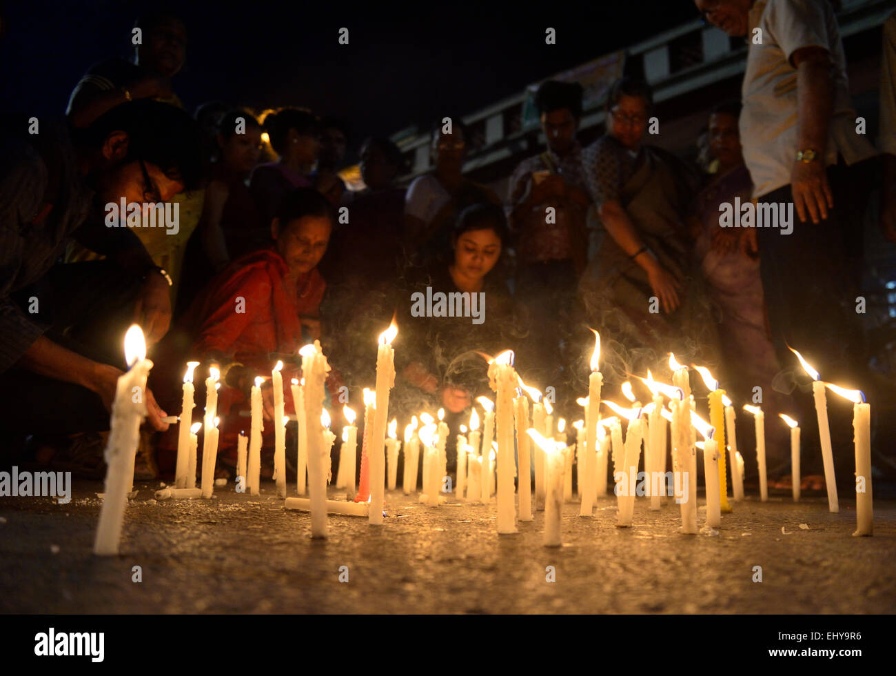 Kolkata, India. 18th Mar, 2015. Indian people offers a candle lightning ...