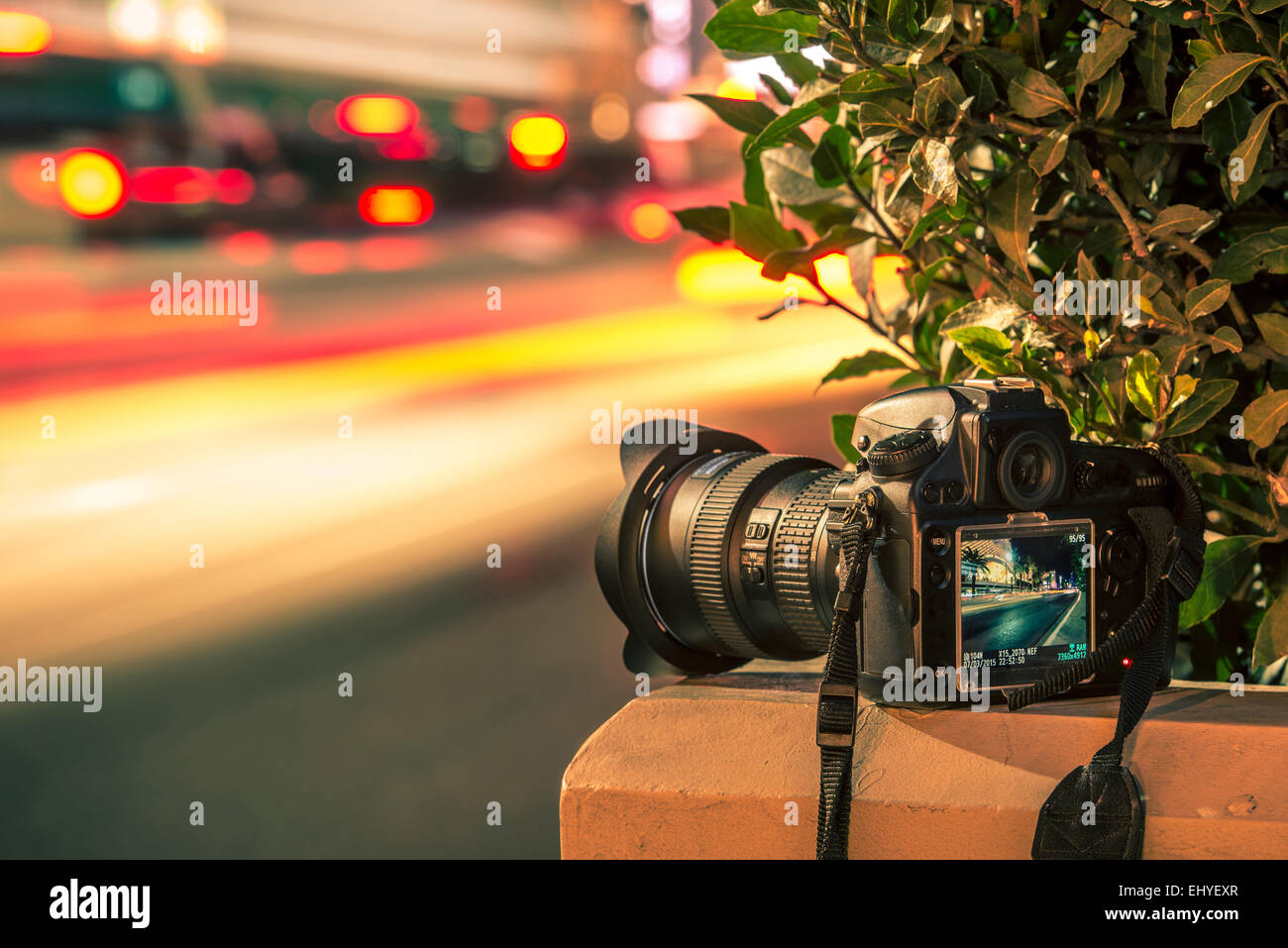 Travel Photography Concept. Professional Digital Camera and Traffic Blurs. Night Long Exposure Photography. Stock Photo