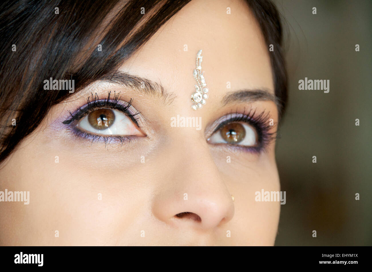 Close up of mid adult woman's eyes and bindi on her forehead Stock Photo
