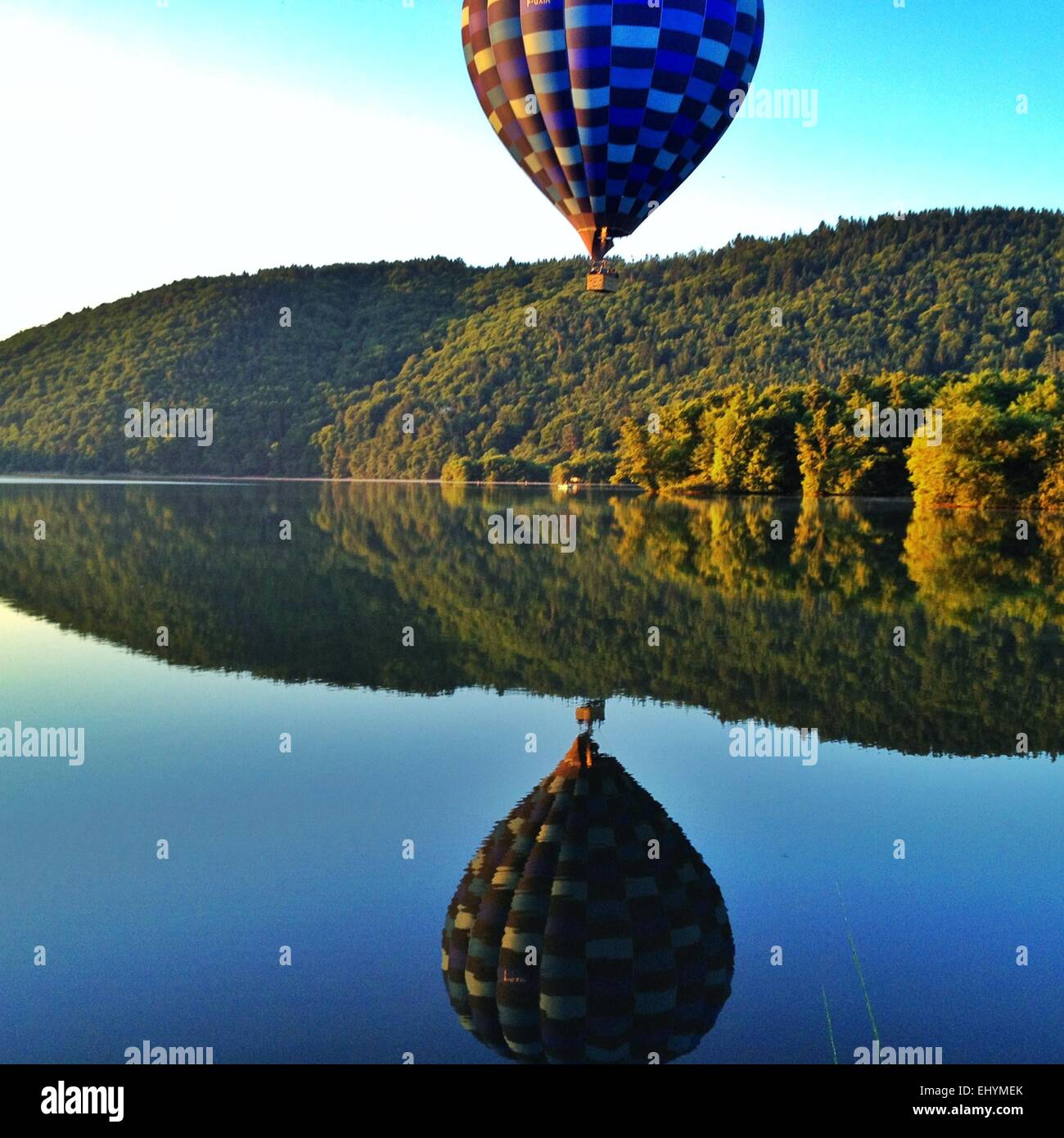 Hot air balloon over a lake in Auvergne, France Stock Photo