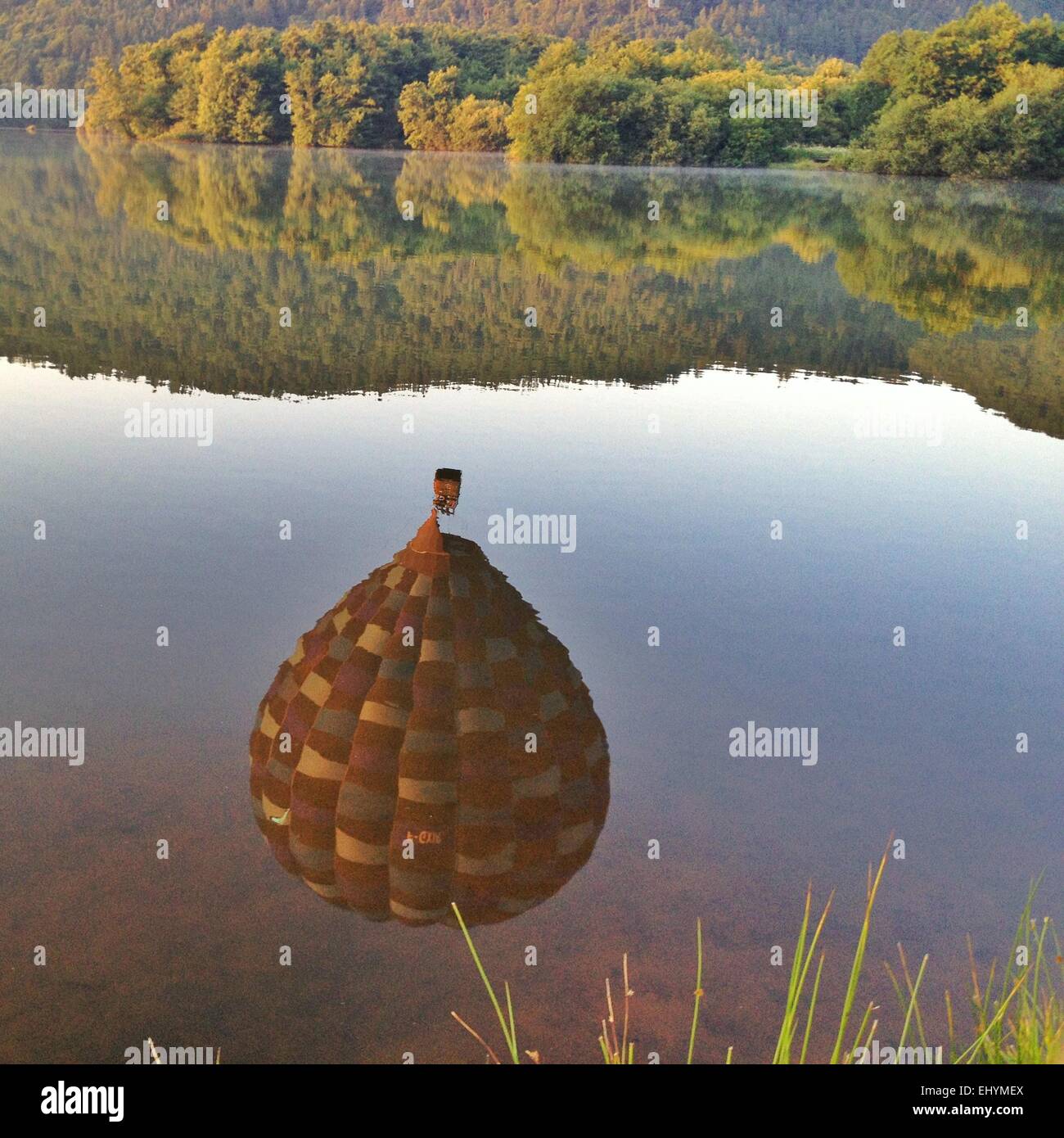 Hot air balloon reflection in a lake, Le Bourget, Auvergne, France Stock Photo