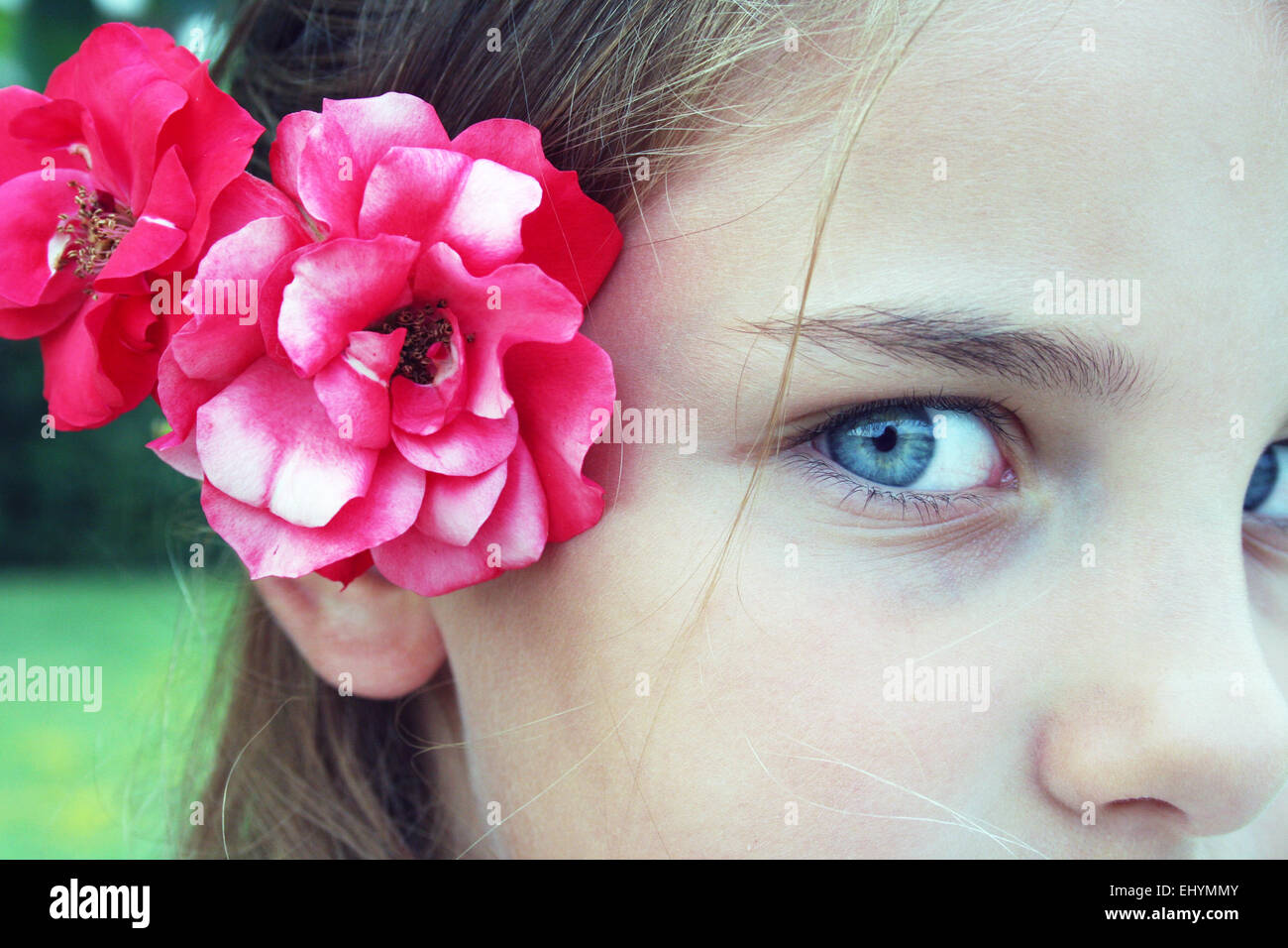 Portrait of a girl with flowers behind her ear, Marche Italy Stock Photo -  Alamy