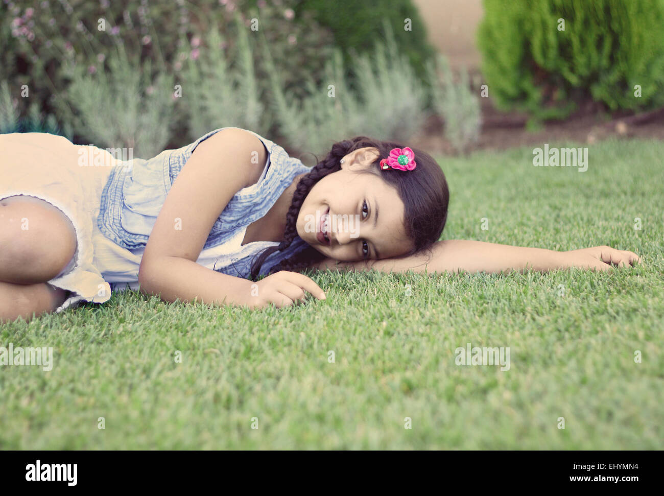 Portrait of a smiling girl lying on grass Stock Photo - Alamy