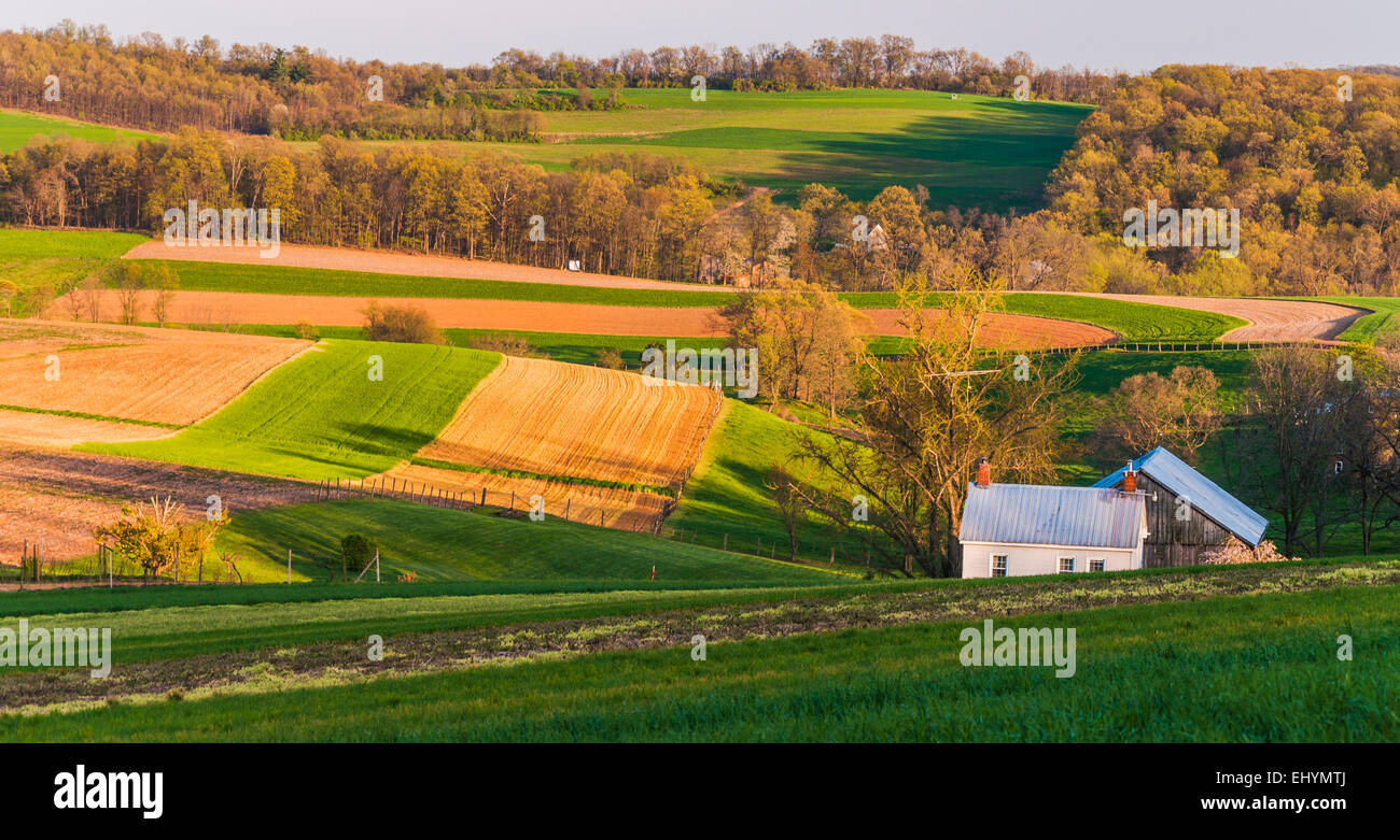 Home and barn on the farm fields and rolling hills of Southern York