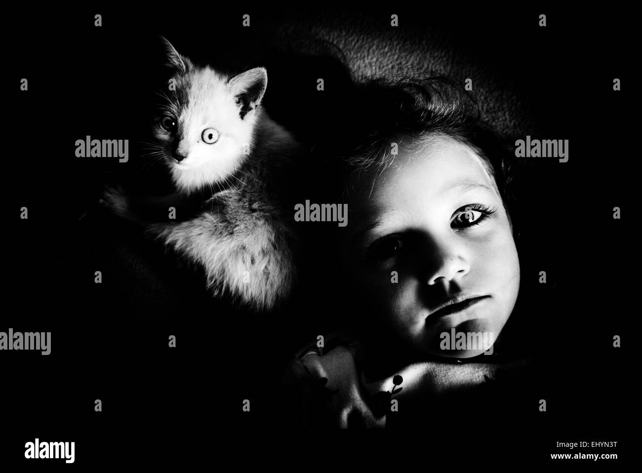 Portrait of a girl lying next to her cat Stock Photo