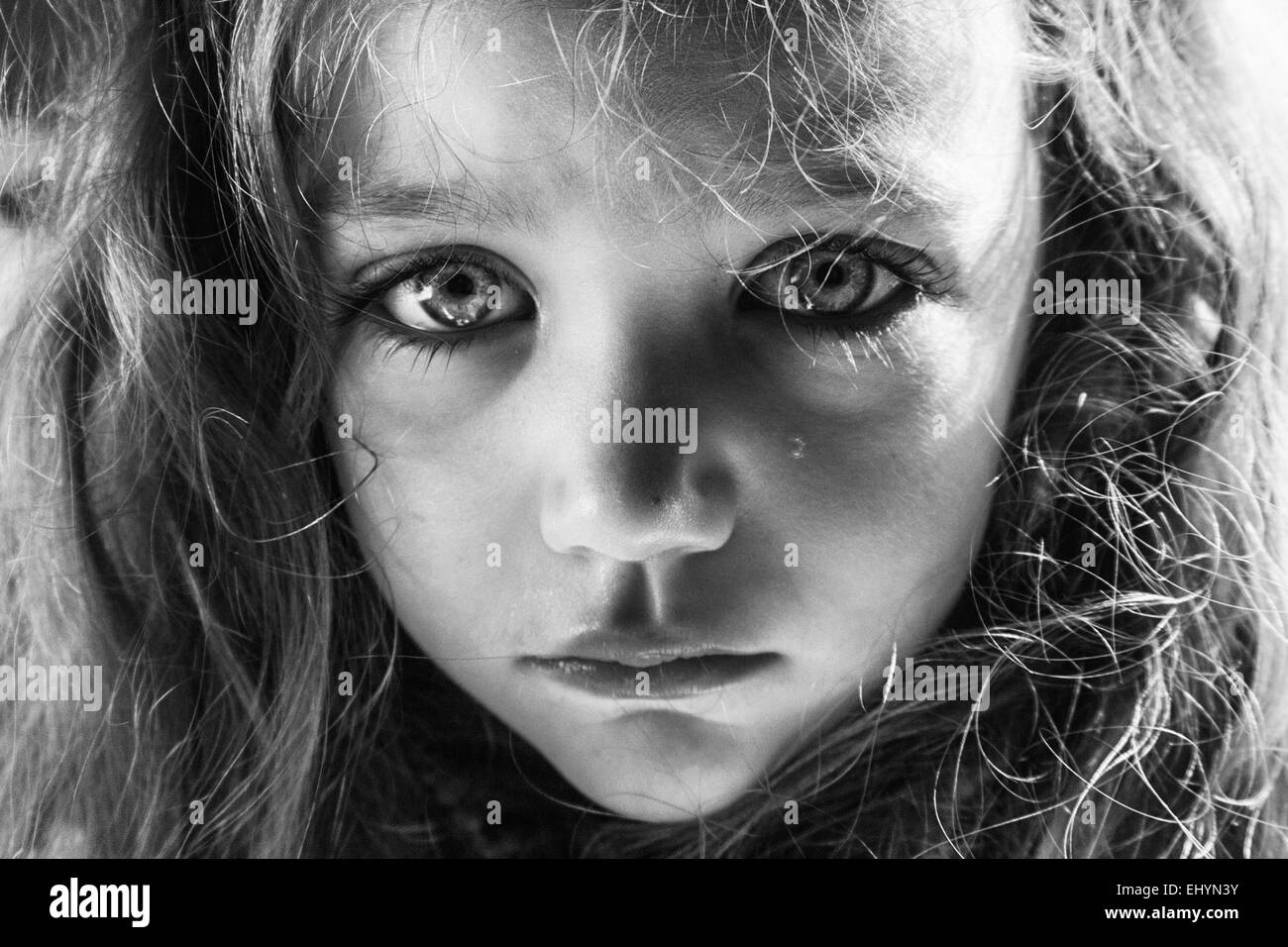 Portrait of a girl crying with a tear running down her face Stock Photo