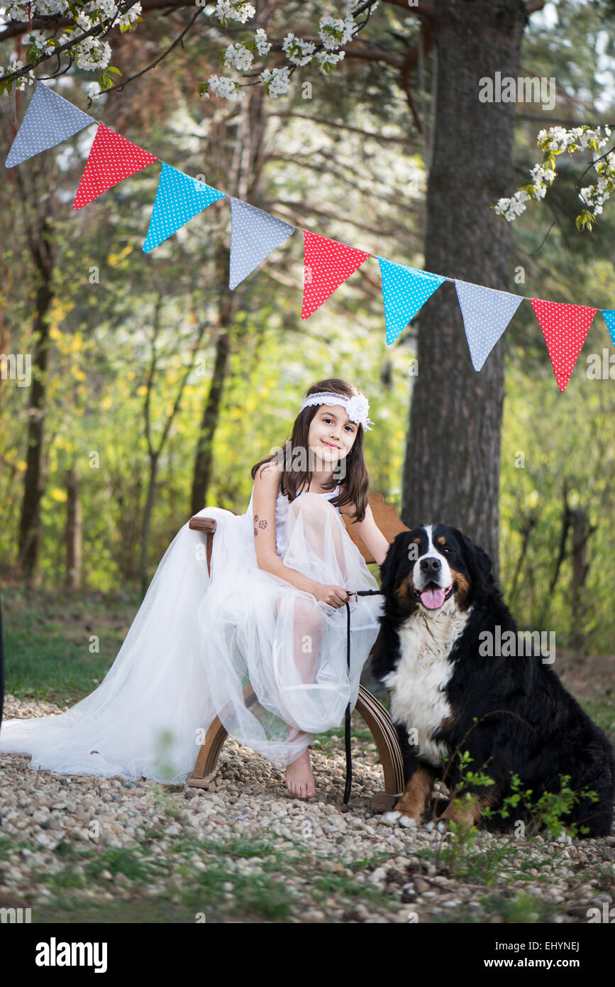 Girl sitting in the garden with a dog Stock Photo - Alamy