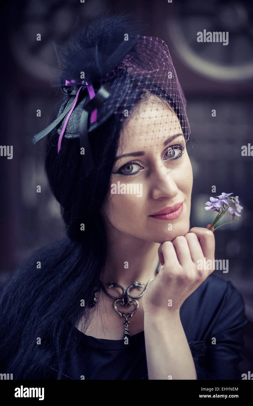 Portrait of a woman holding a flower Stock Photo