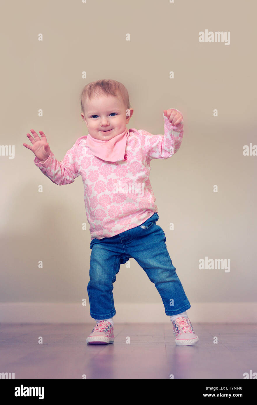 Baby girl taking her first steps Stock Photo