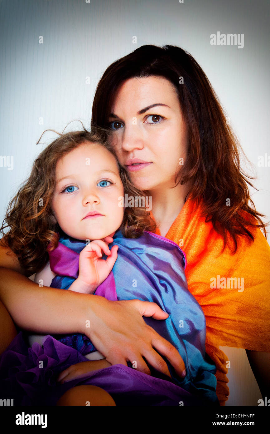 Portrait of a girl sitting on her mother's lap Stock Photo