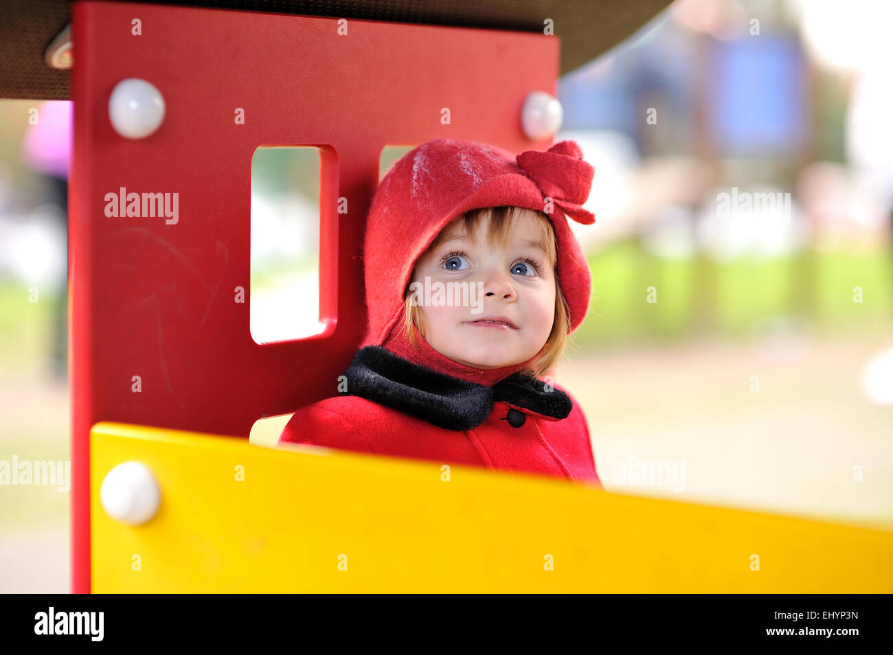 Girl in a red hat sitting in a playhouse Stock Photo Alamy