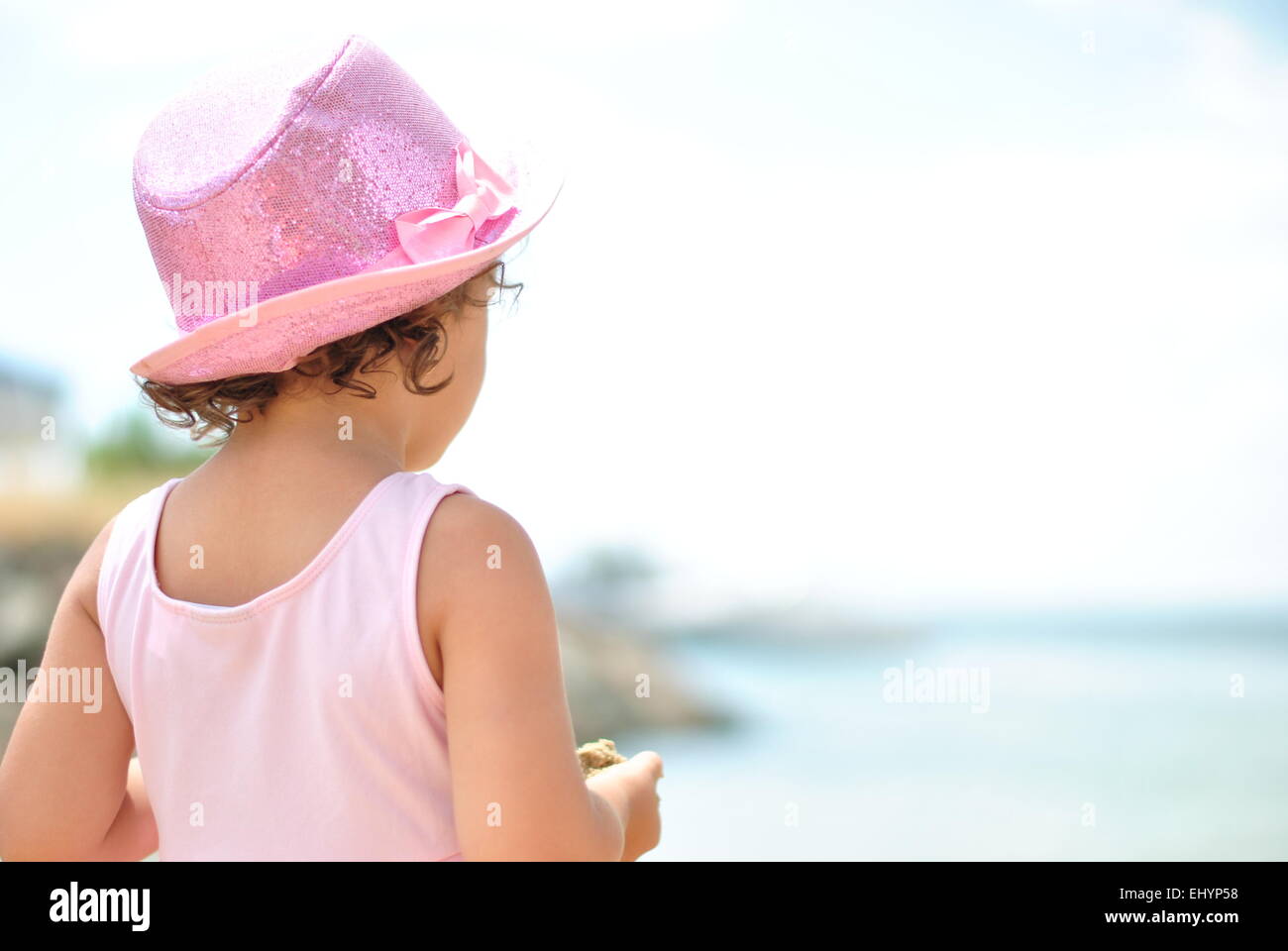 Rear view of a girl looking out to sea Stock Photo