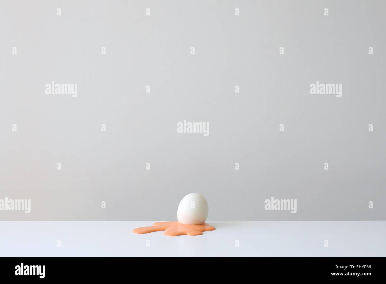 Conceptual egg shell on yellow yolk Stock Photo