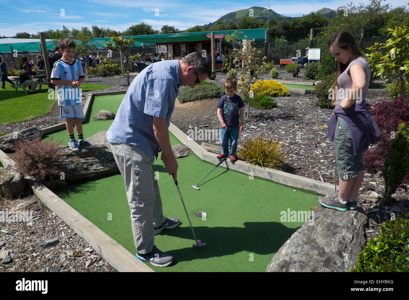 Family playing crazy golf, near Dunedin, New Zealand Stock Photo