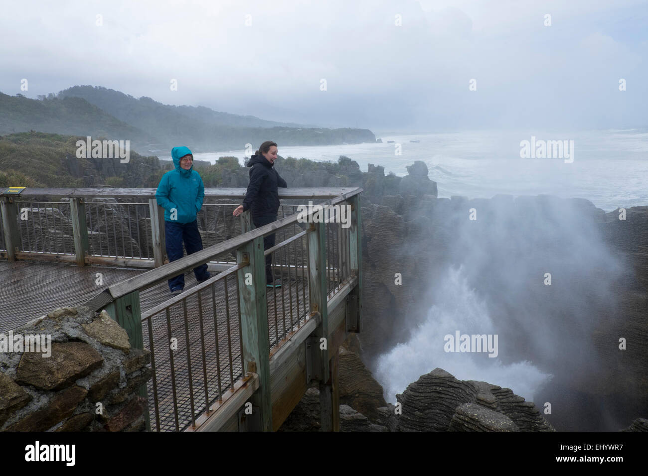 Tourists watch Blowhole at Punakaiki (Pancake Rocks), South Island, New Zealand Stock Photo