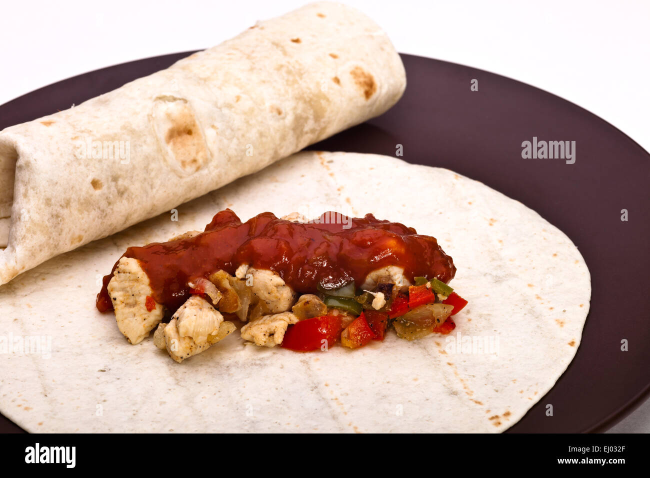 Burritos with chicken pepper onion garlic and sauce Stock Photo Alamy