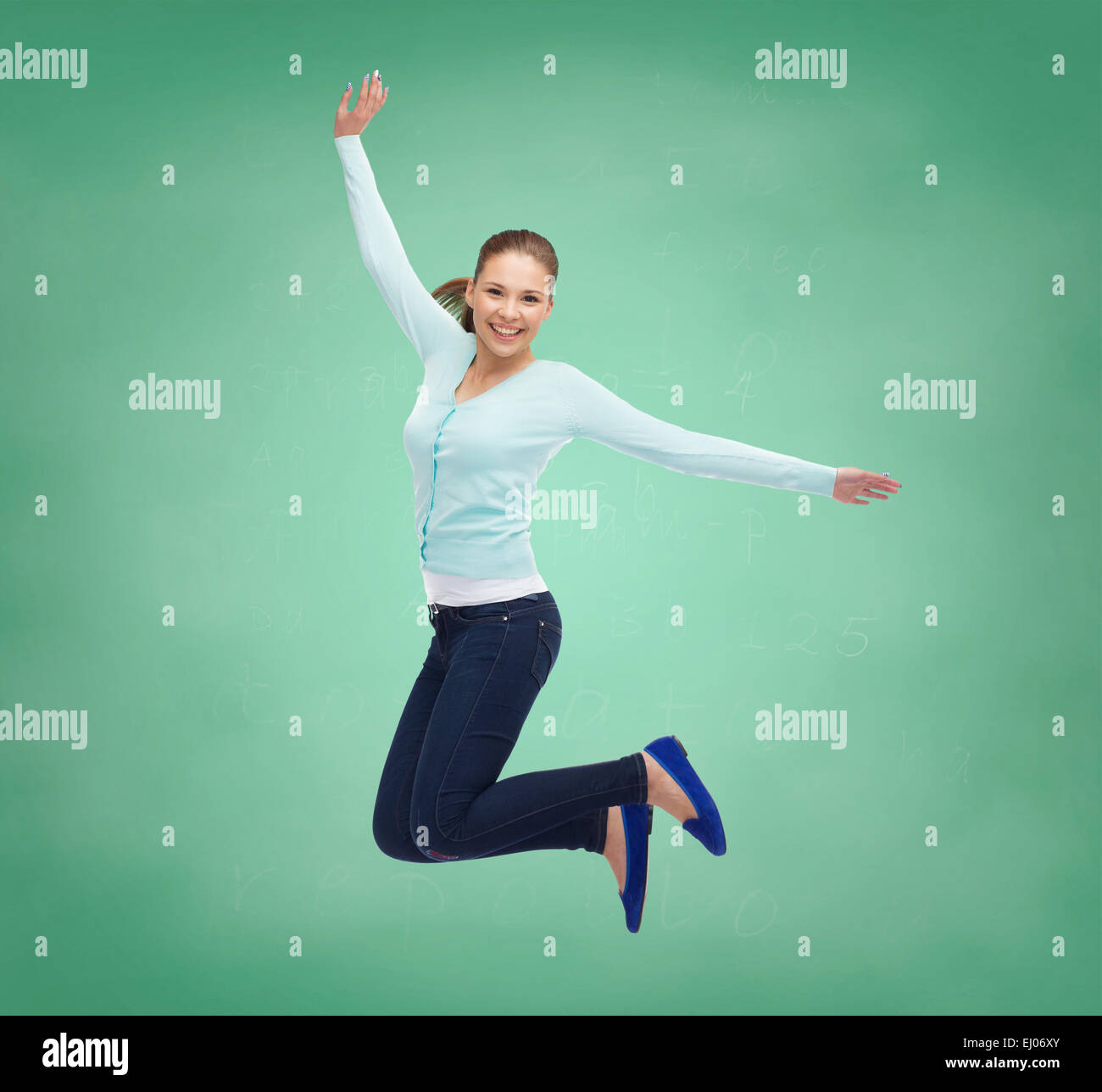 smiling young woman jumping in air Stock Photo - Alamy